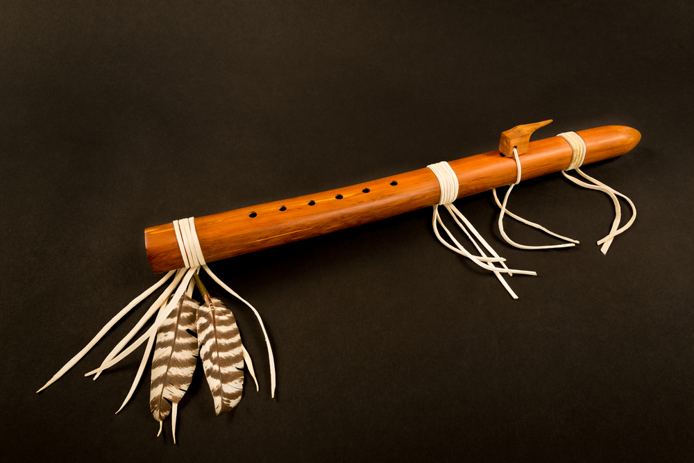Native flute with feathers and string