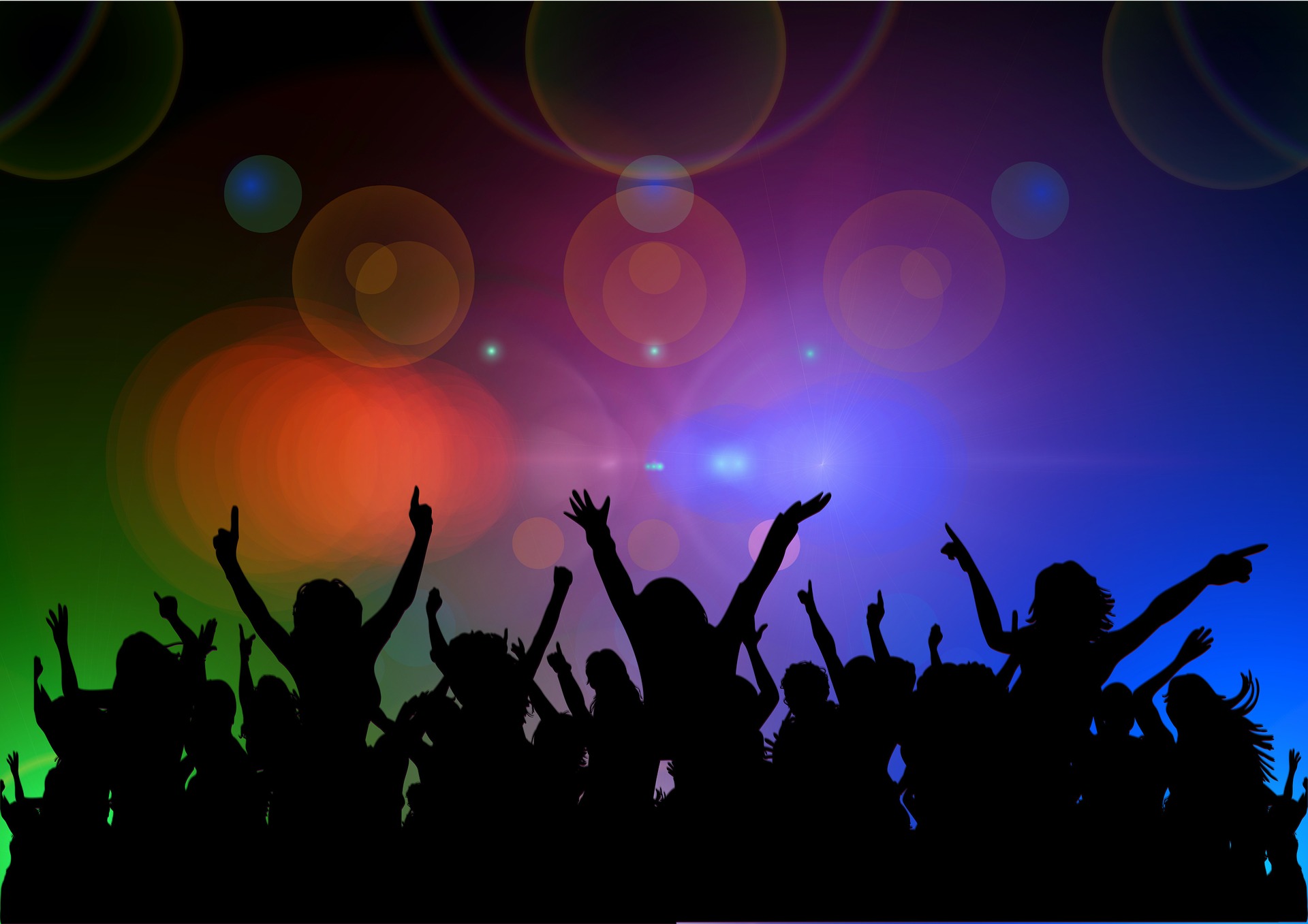 silhouette of crowd dancing with colorful background