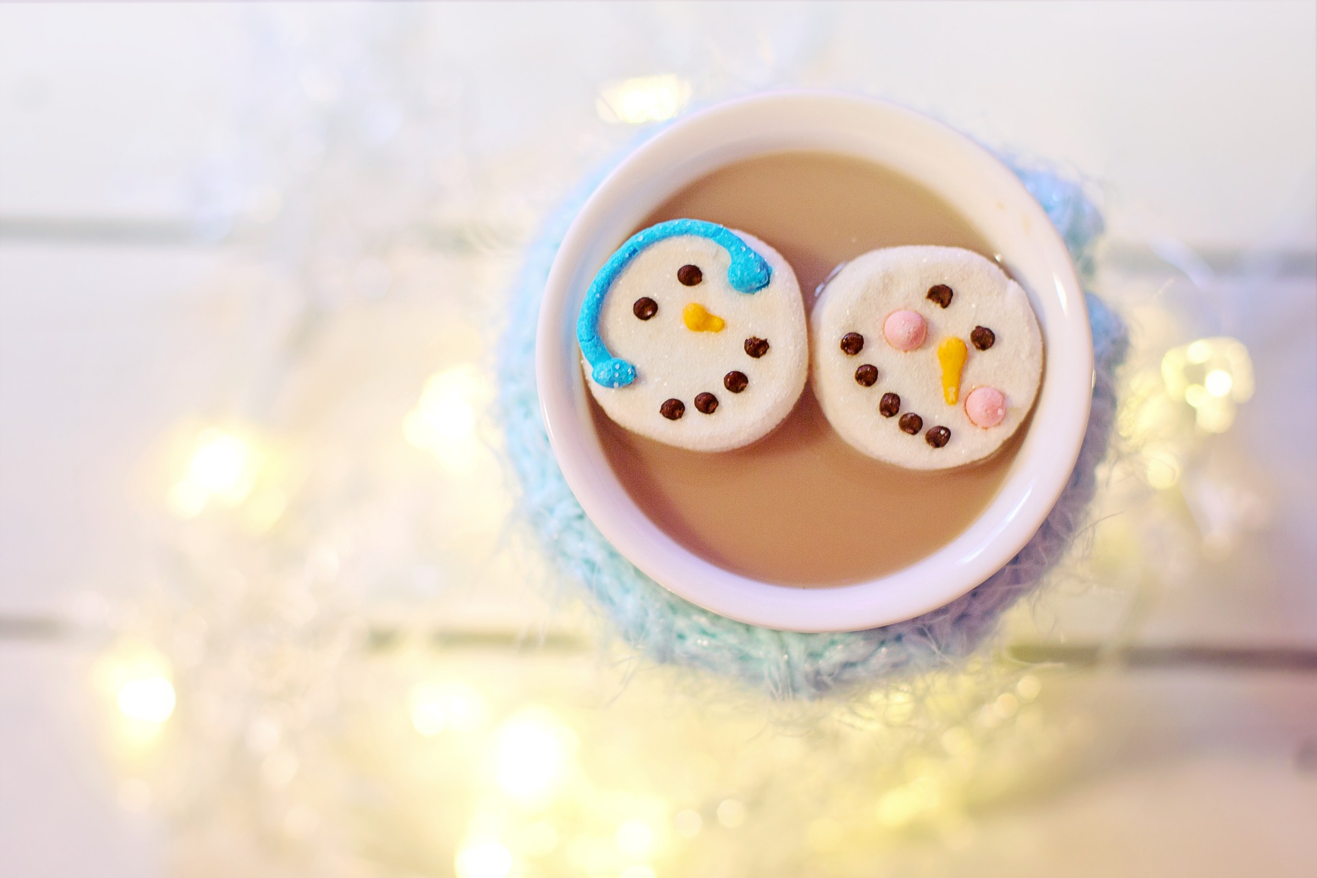 Overhead shot of a mug of hot chocolate with snowman marshmallows in it