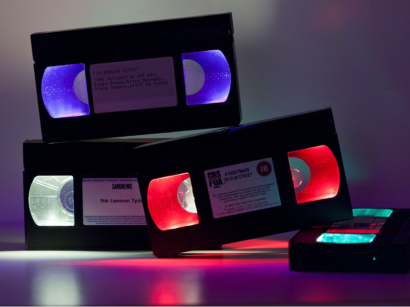 VHS tapes altered with red, blue and white lights.