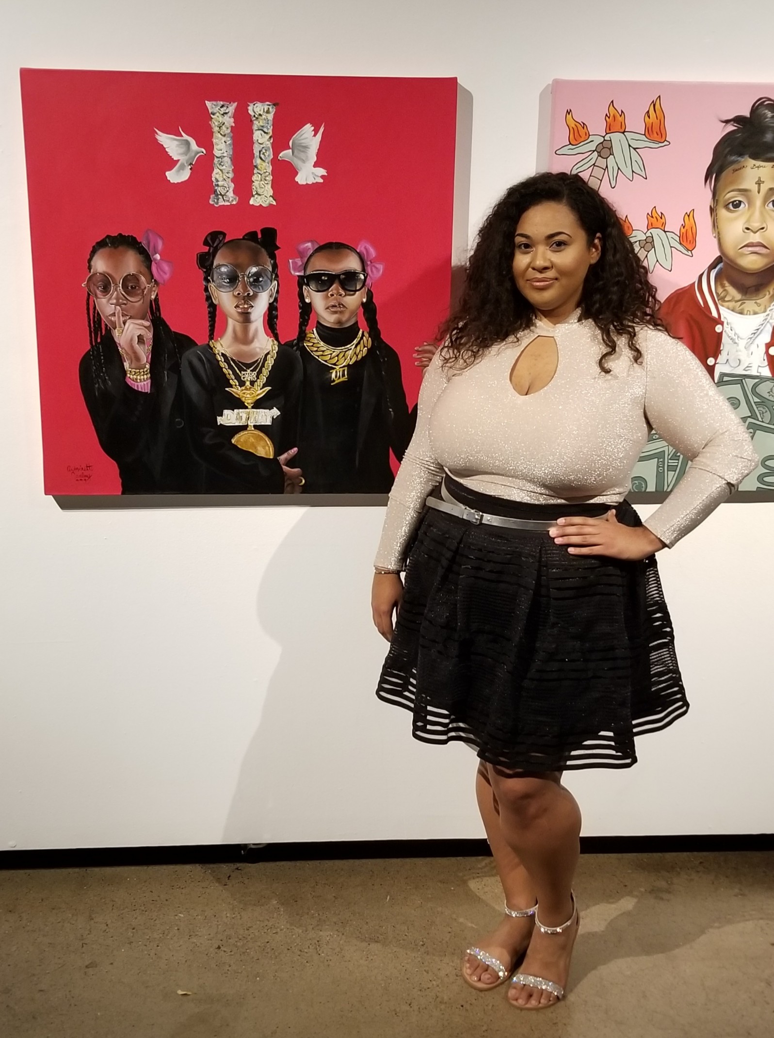 Artist Antoinette Cauley standing next to her work in a gallery