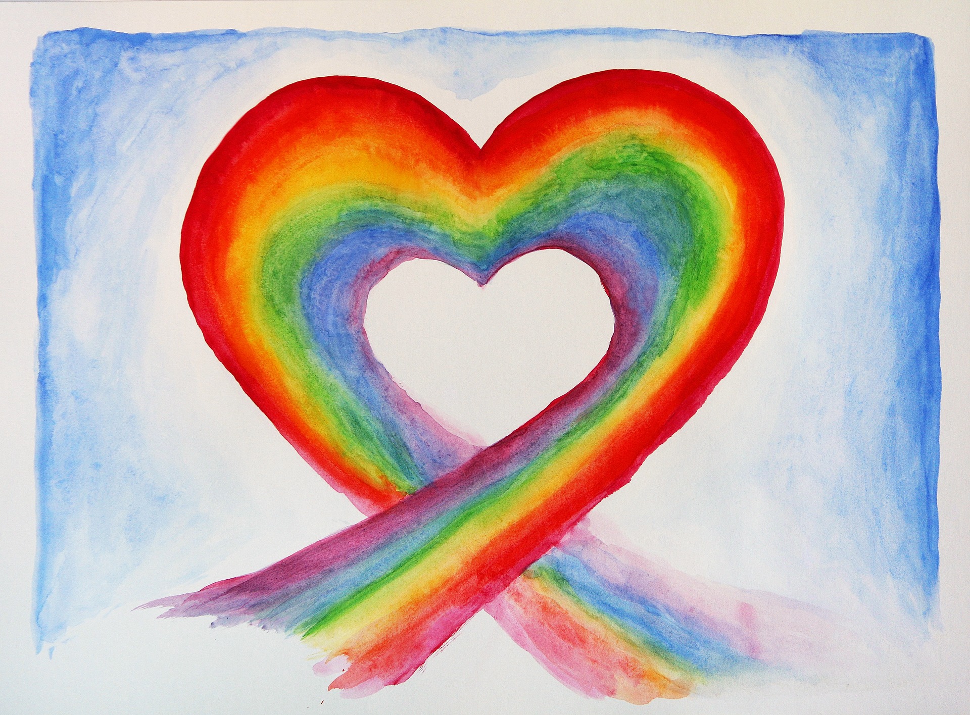 Watercolor painting with a blue background and a rainbow-colored heart