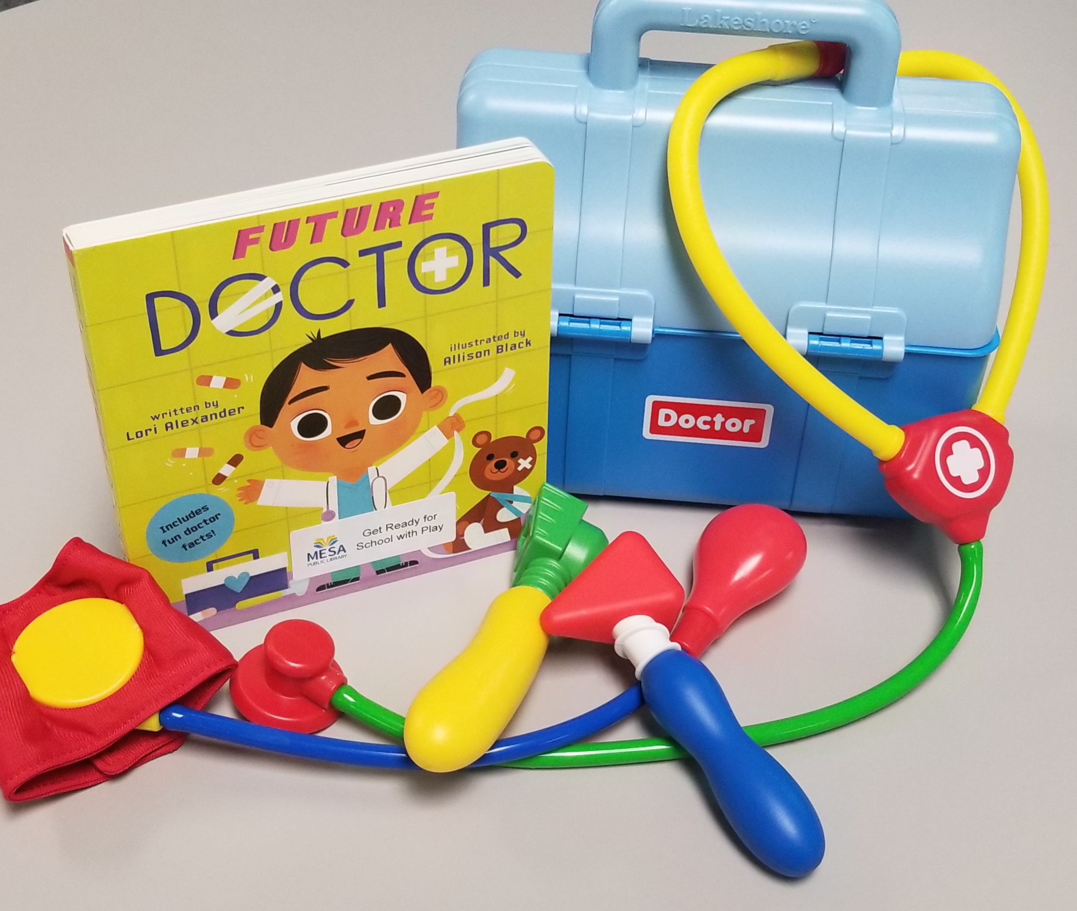 Picture of a doctor playset with multiple toys and a book, "Future Doctor"