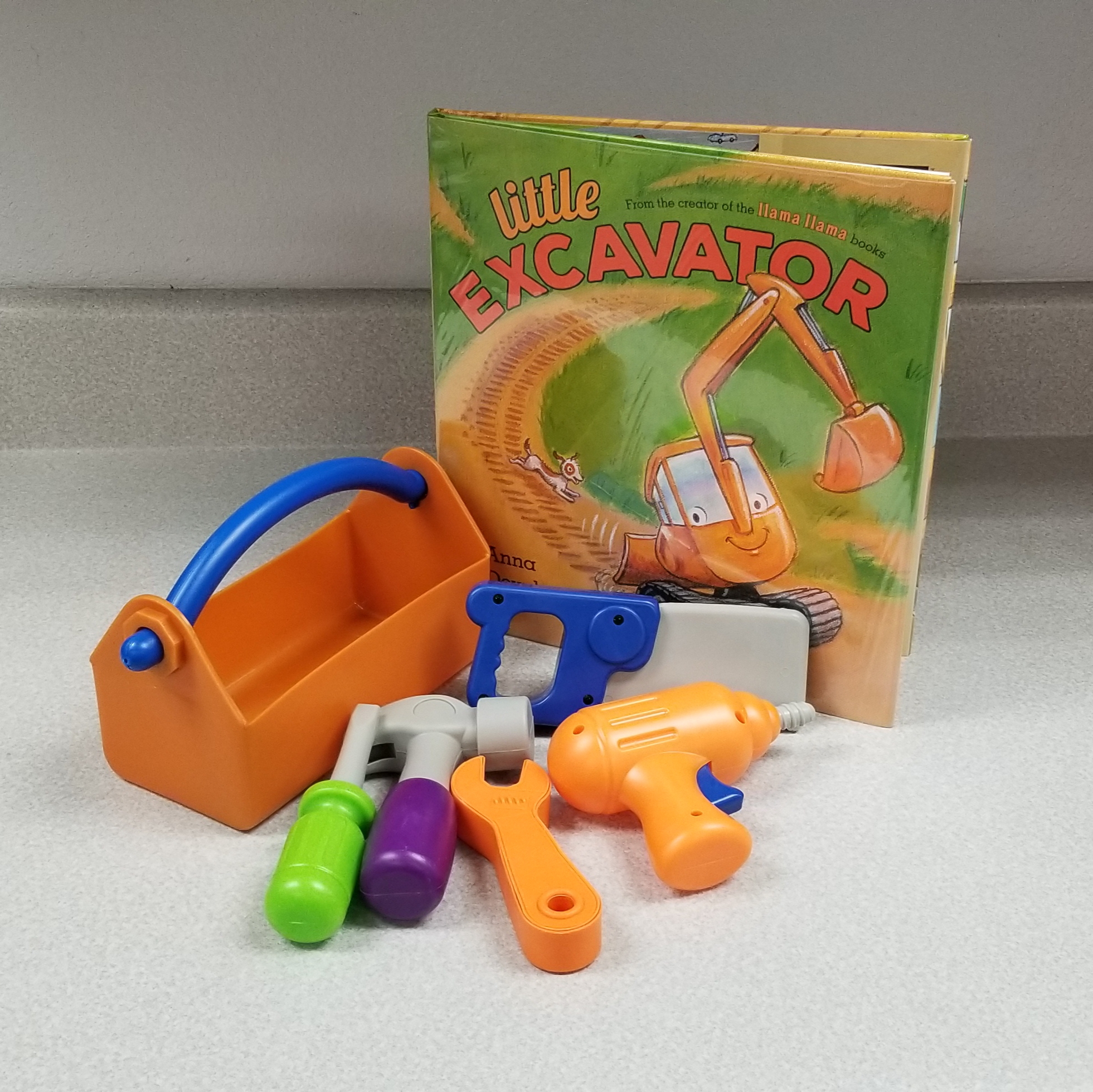 Image of toy toolbox and various tools with book "Little Excavator"