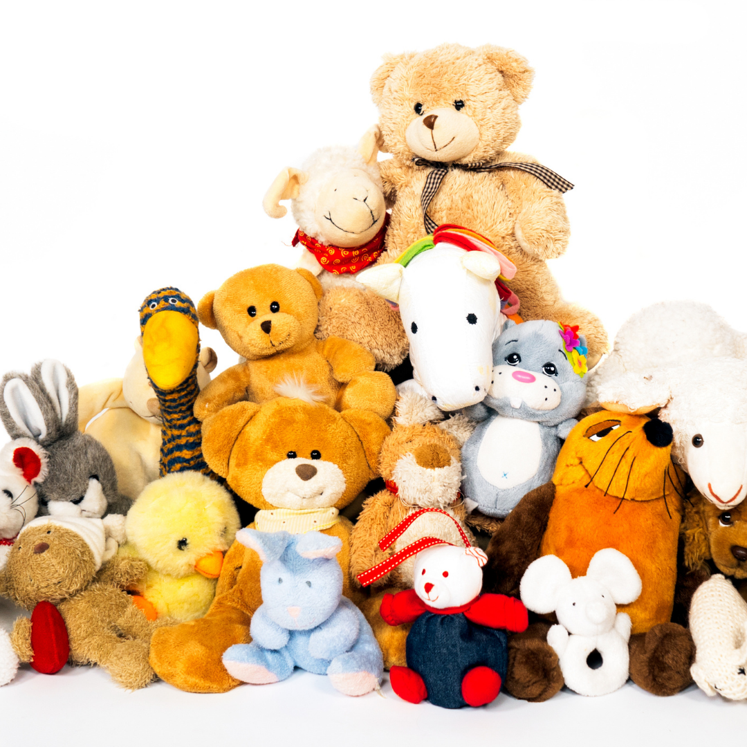 photograph of a variety of stuffed animals stacked on each other
