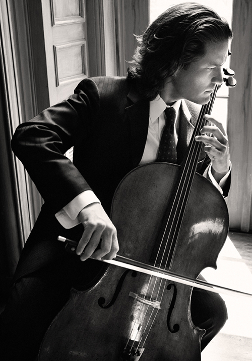 Zuill playing cello in black and white