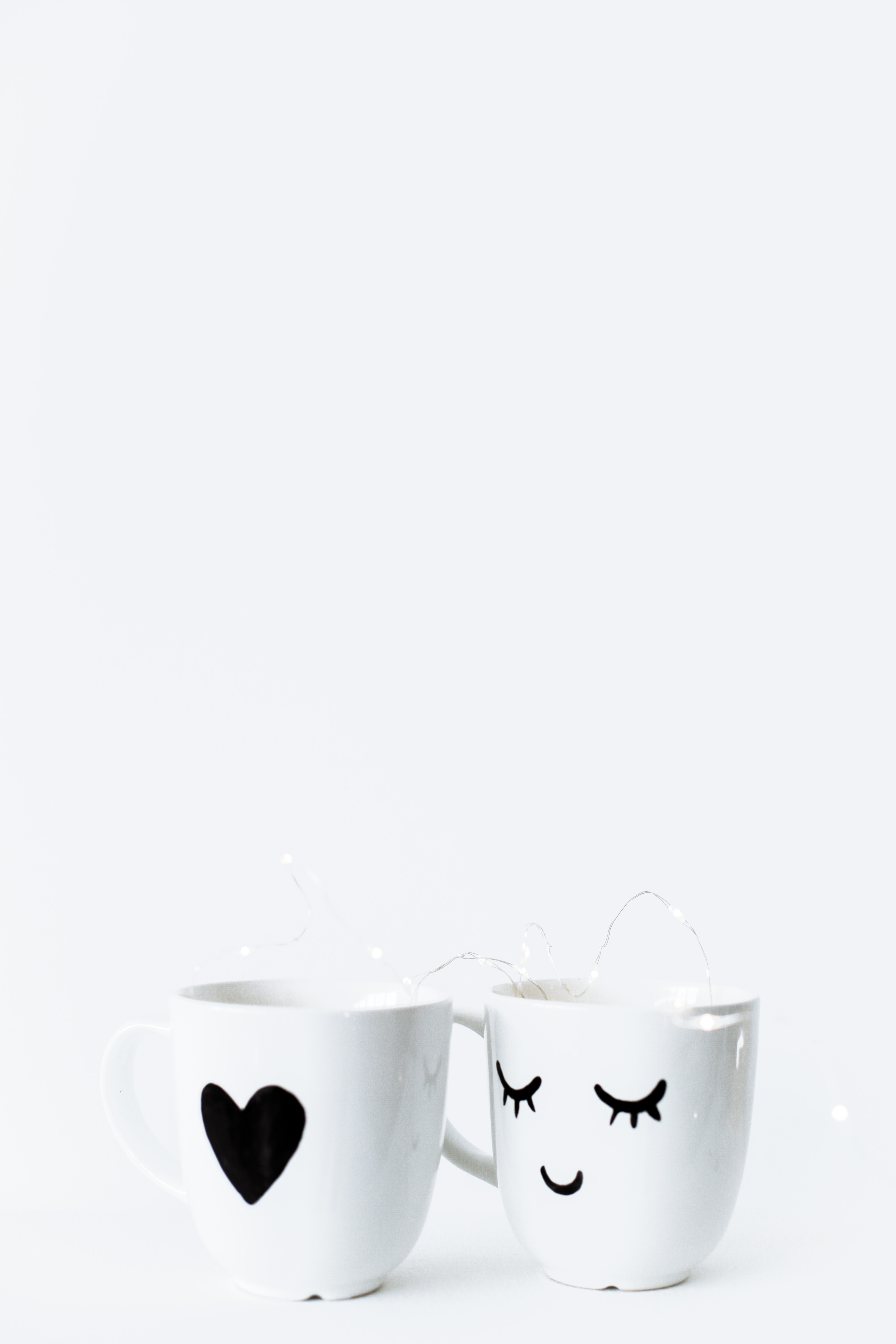 white mug with a heart white mug with a smiley face against a white background
