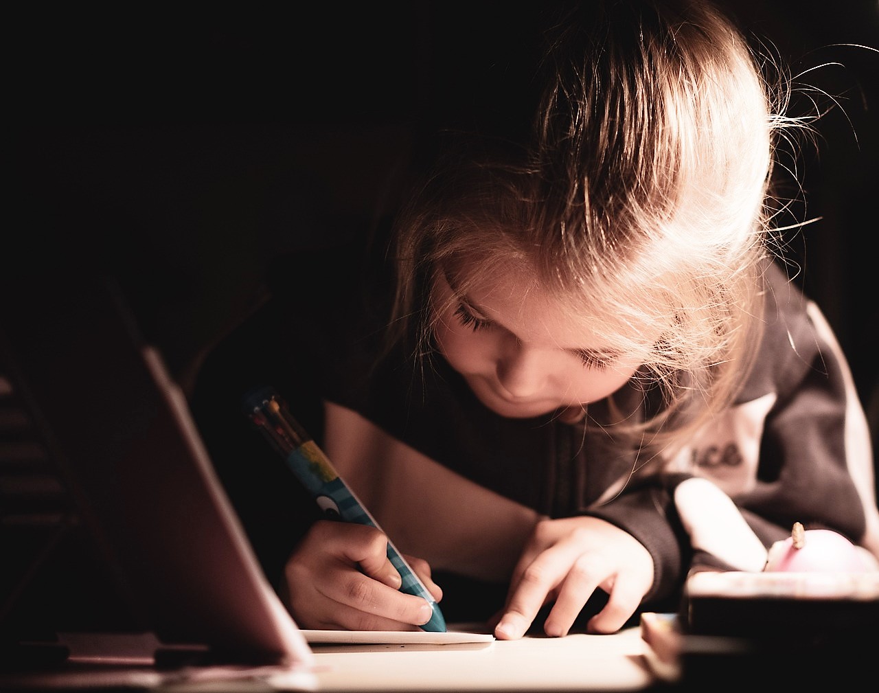 Young girl writing at desk