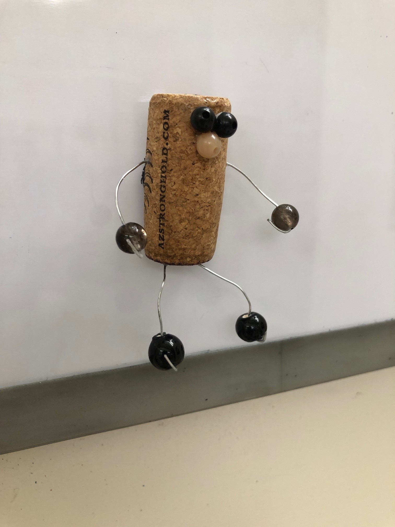 wine cork with beads and wire arms and legs