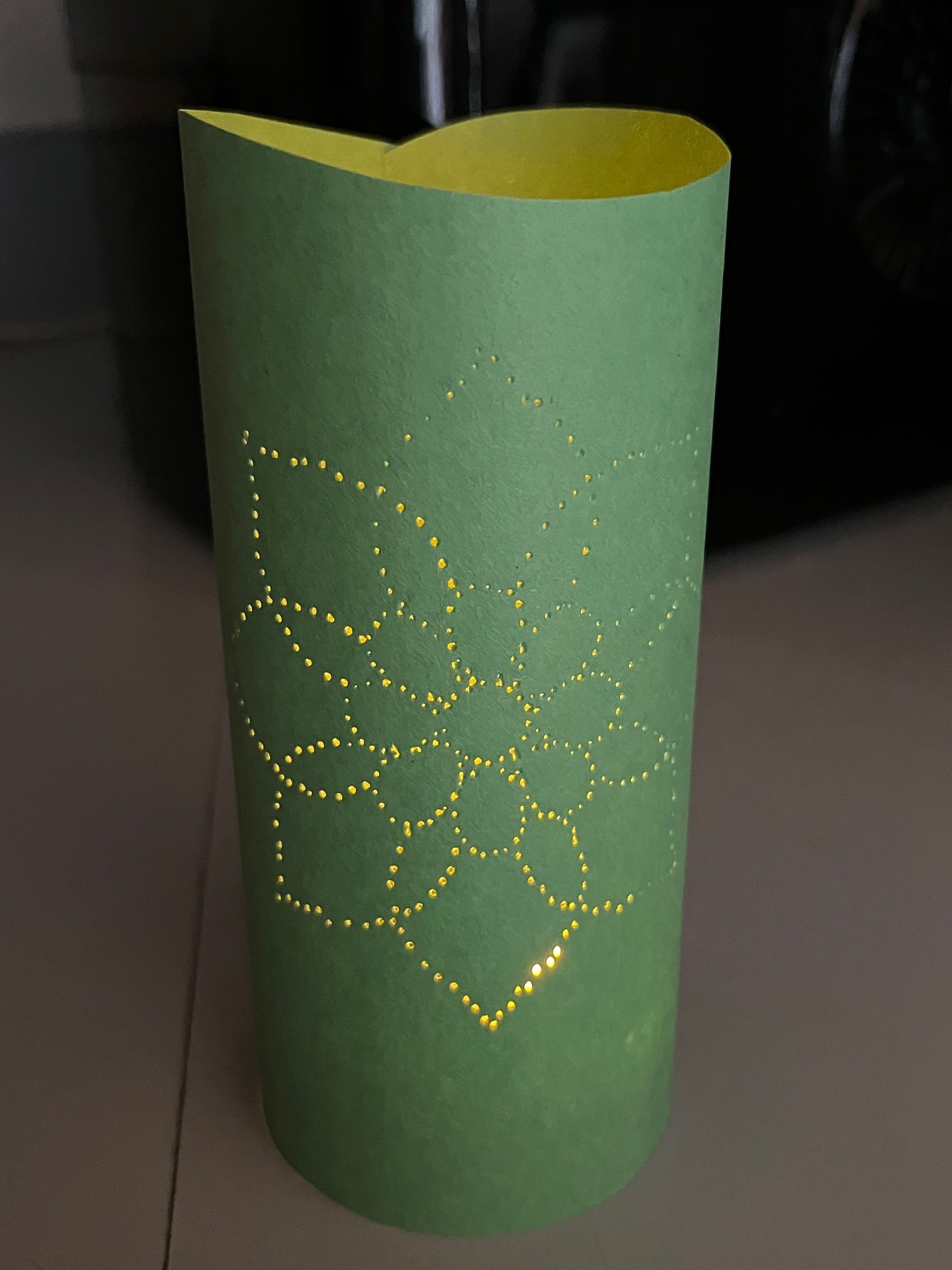 green paper with illuminated flower design