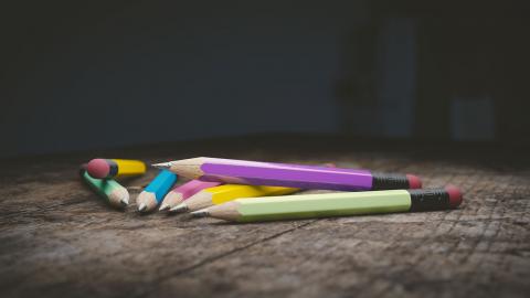Bright colored pencils on a tabletop.