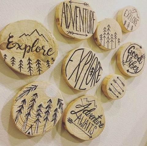 Wood pendants that have been burned to create different art and sayings.