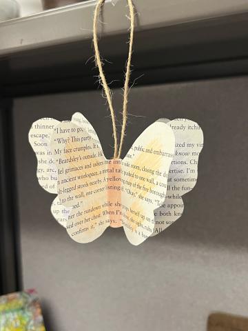 butterfly shape made from book page hanging on a twine loop