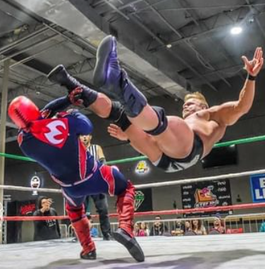 Luchador wrestlers in a match.