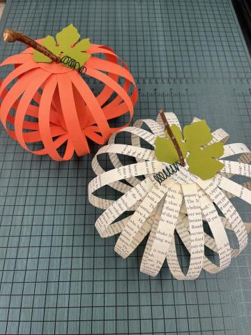 paper pumpkin made from orange paper and paper pumpkin made from old book pages