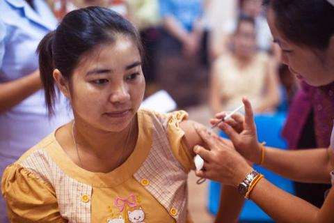 Woman getting a vaccine shot in her arm.