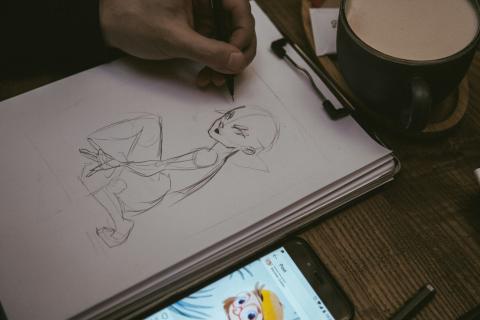 A manga woman being drawn on a sketchpad.