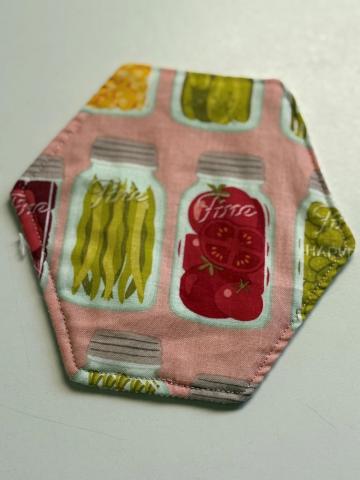 Hexagon shaped cloth jar opener with canned food design material.