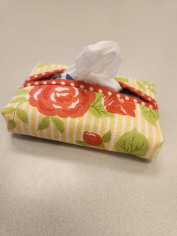 a yellow and red floral cloth mini tissue packet holder
