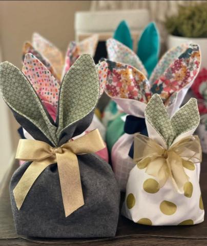 Small cloth gift bags with bunny shaped "ears" tied together with ribbon