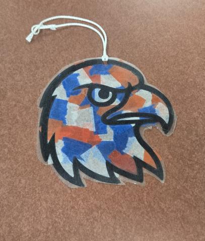 Bald Eagle with red white and blue paper taped to it and a string at the top to hang.
