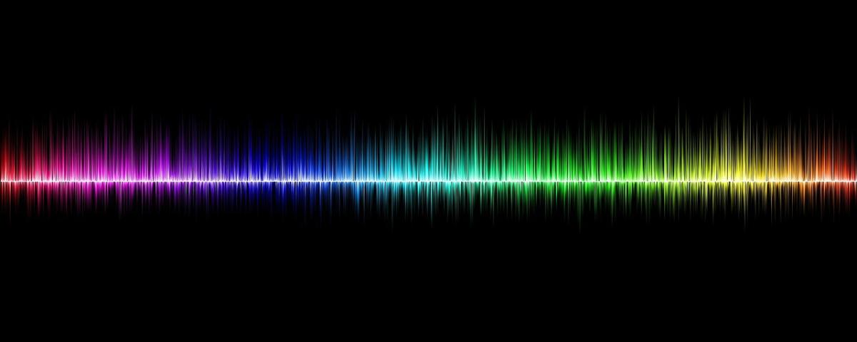 Black background with rainbow-colored soundwaves