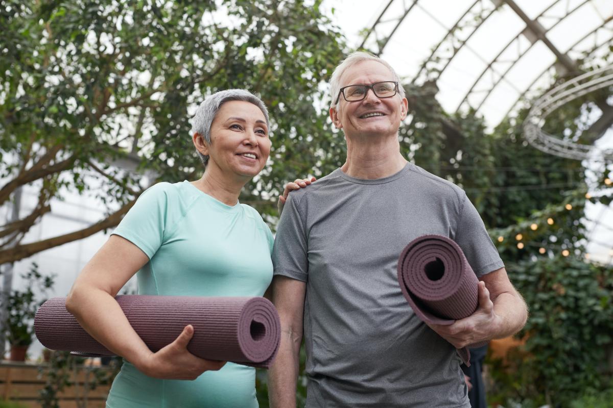 couple holding yoga mats