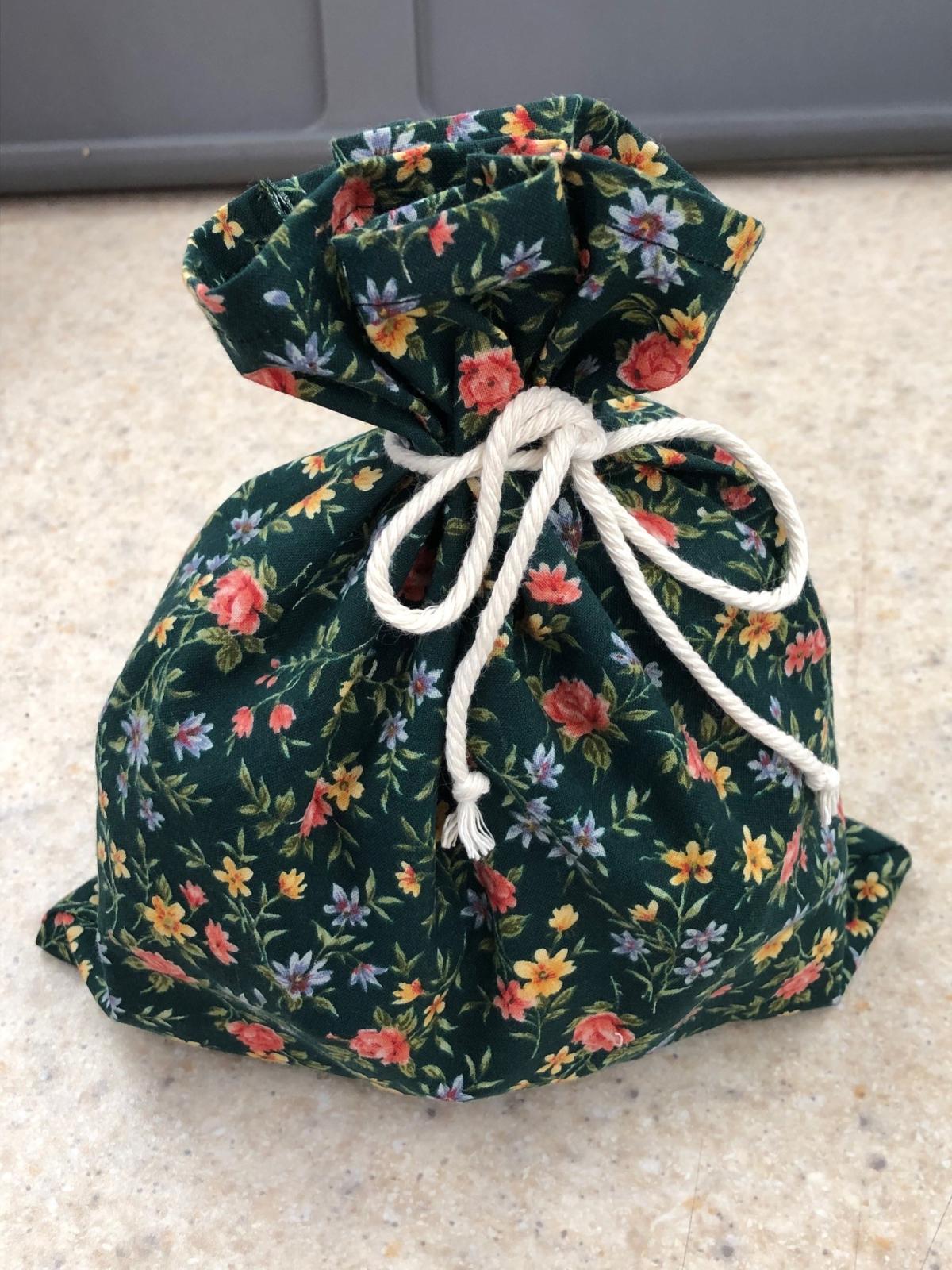 green fabric bag tied with cord