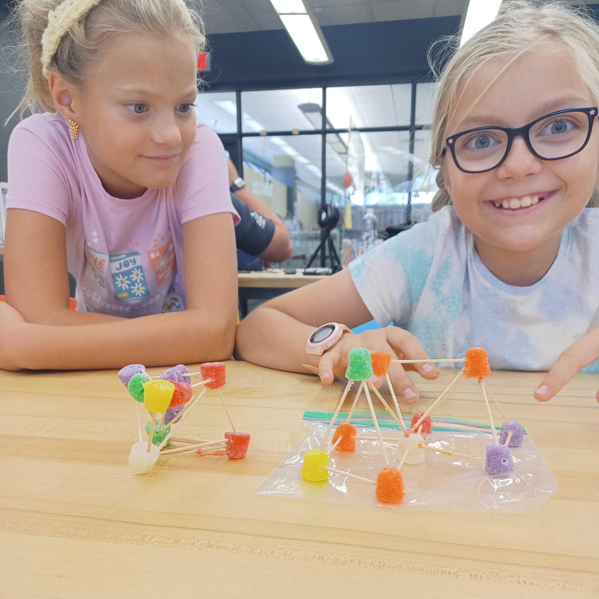 girls building with toothpicks