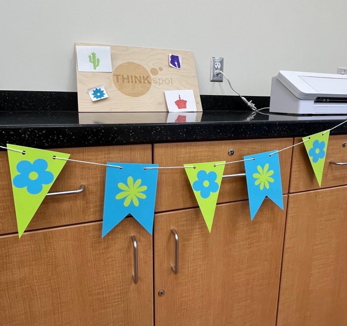 blue and green flower banner draped on edge of counter