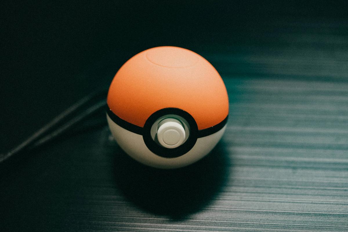 A small Pokeball resting on a table.
