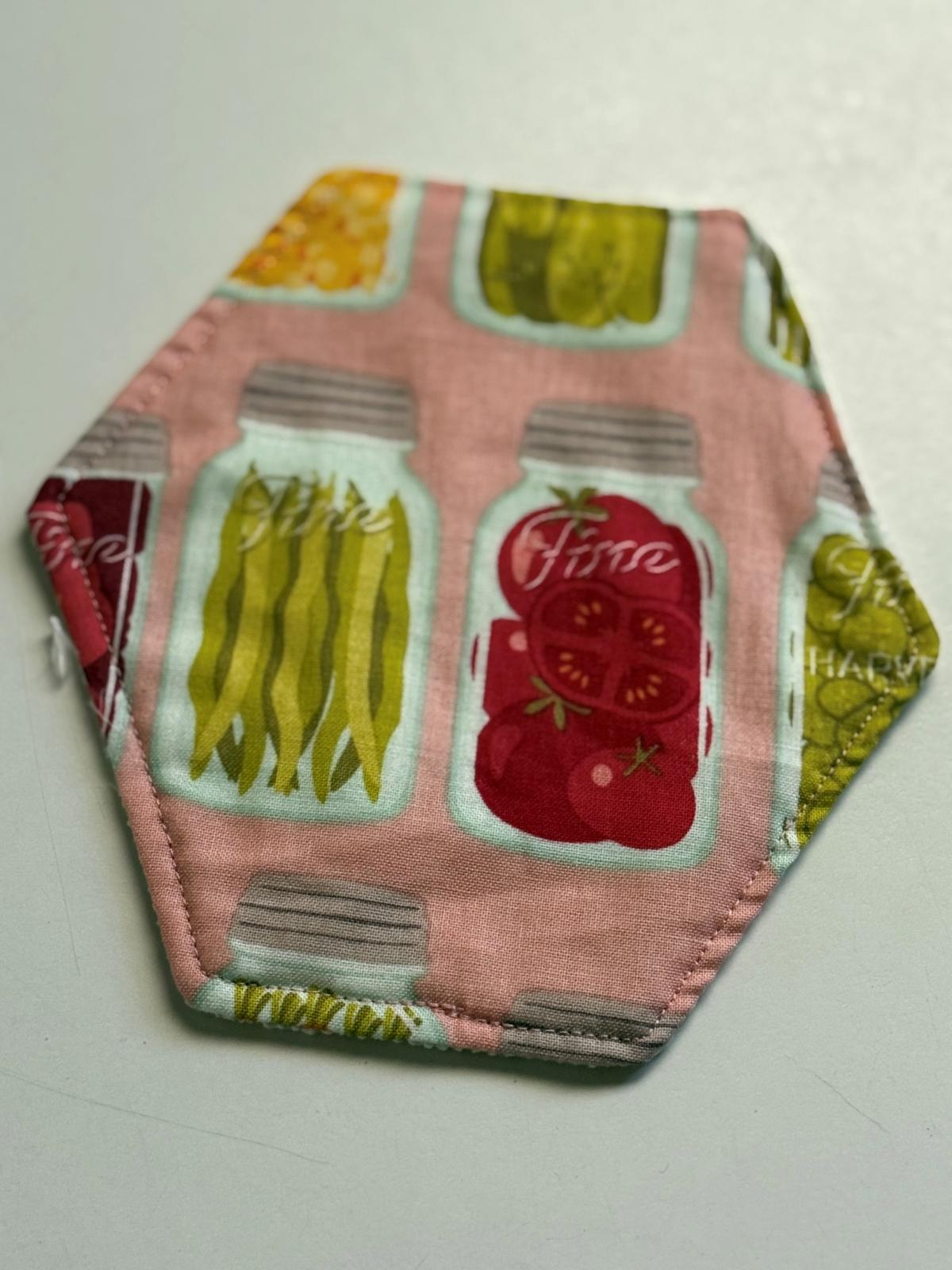 Hexagon shaped cloth jar opener with canned food design material.