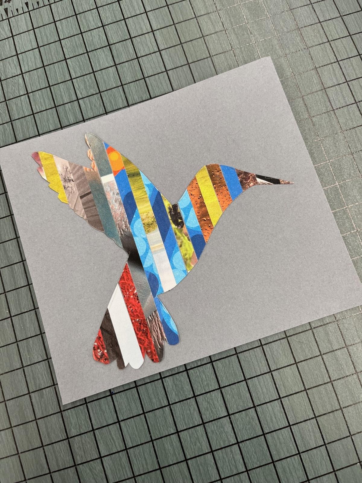 hummingbird silhouette made of strips of magazine paper