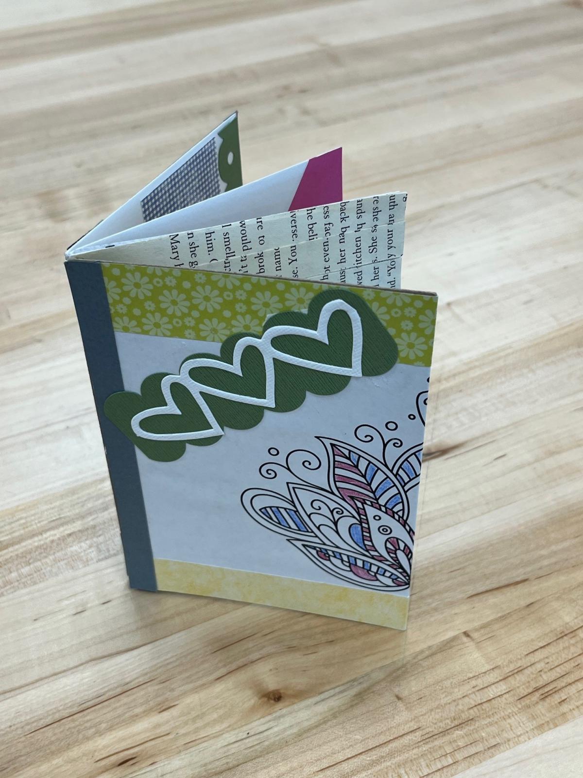 small paper scrapbook decorated with colorful papers