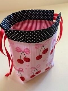 Cherry and polka dot pattern drawstring bag with red drawstrings